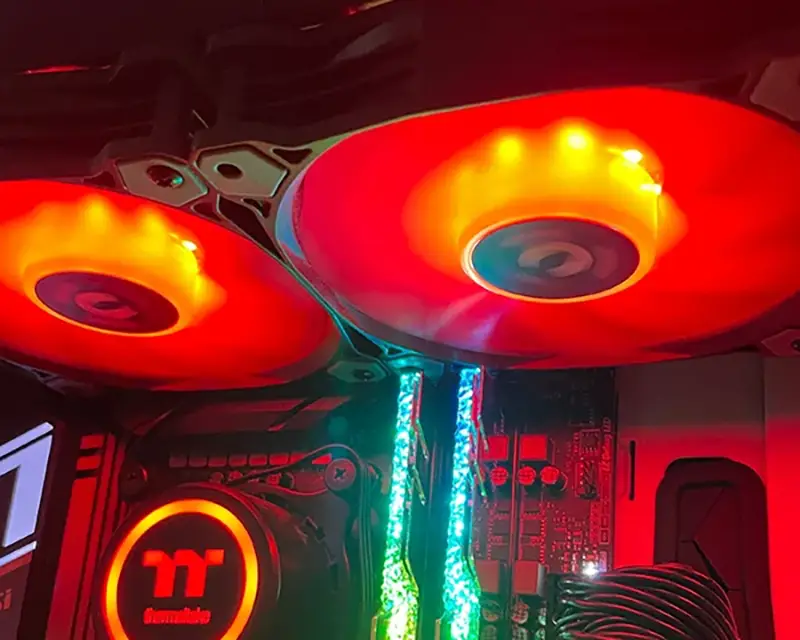 Gaming PC with loud red cooling fans and illuminated RAM sticks